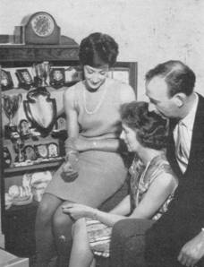 1966 Gloria Dourass at home with parents and trophies MBM-Wi66P32.jpg